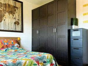 a bedroom with a bed and a dresser and cabinets at Moderno Attico a due passi dal Mare in Senigallia