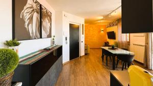 a living room with a desk and a dining room at Moderno Attico a due passi dal Mare in Senigallia +7 photos