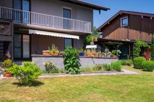 a house with a garden in front of it at Ferienwohnung Lois ***** in Eggstätt