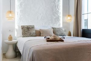 a white bedroom with a bed with a white wall at Villa Zendaya in Yaiza +49 photos