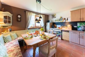 a kitchen with a table with food on it at Ferienwohnung Lois ***** in Eggstätt
