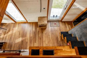 ein Zimmer mit Holzboden, Treppe und Fenstern in der Unterkunft Tiny House - Rolling Tiny - Wanderfalke in Groß Kordshagen