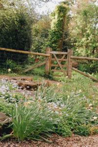 a wooden fence in a garden with flowers at Little Underhill in Oswestry +62 photos
