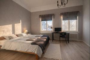 a bedroom with a large bed and a desk at Wärdshuset Liden in Liden