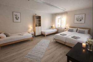 a bedroom with two beds and a table and a table sidx sidx sidx at Wärdshuset Liden in Liden
