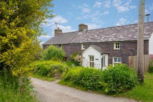 a brick house with a gravel road in front of it at Ty Top in Newport