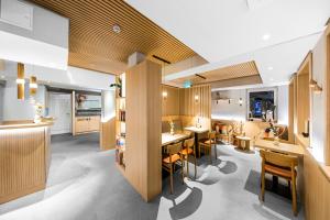 a restaurant with wooden walls and tables and chairs at Bude54 in Sankt Peter-Ording