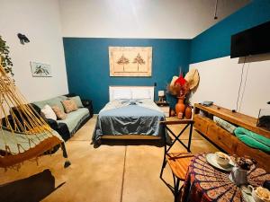 a room with a bed and a couch in it at Chalé Cabana c/ Hidro, Vista e Superhost -Jundiaí in Jundiaí
