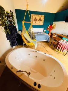 a bath tub with a hammock in a room at Chalé Cabana c/ Hidro, Vista e Superhost -Jundiaí in Jundiaí +41 photos
