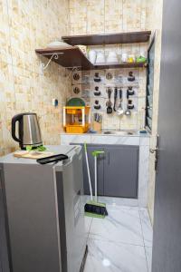 a small kitchen with a counter and a stove at Résidence Gnimakel in Abidjan