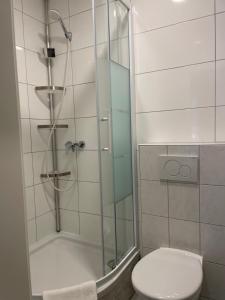 a bathroom with a shower with a toilet and a sink at Hotel M68 in Berlin +45 photos