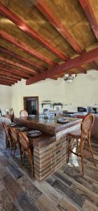 a kitchen with a large wooden table and chairs at Rancho Espinoza La Casita in San Ignacio