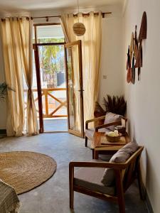 a living room with a couch and a table at Olacoco by Olamanga in Jambiani
