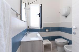 a bathroom with a sink and a toilet at Residence Emmesse in Zambrone +52 photos