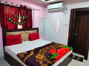a bedroom with a bed with a happy birthday sign on it at Hotel Neelkanth in Vrindāvan