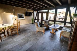 a large living room with a table and chairs at Rosenberghof in Hillesheim