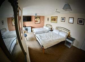 ein Schlafzimmer mit drei Betten und einem Spiegel in der Unterkunft O'Gradys Hotel in Redcar