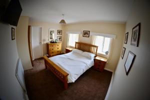 ein Schlafzimmer mit einem Bett und zwei Fenstern in der Unterkunft O'Gradys Hotel in Redcar