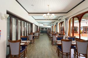 a dining car of a train with tables and chairs at Cumberland Hotel & Conference Centre Worcester in Worcester