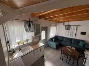a living room with a blue couch and a table at Spitaki in Kremasti
