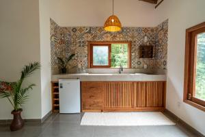 a kitchen with a sink and a window at Casa Xibas e Loft Trancoso in Trancoso +50 photos