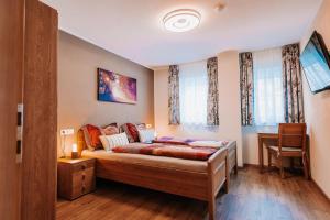 a bedroom with a large bed and two windows at App. Marlos in Leisach