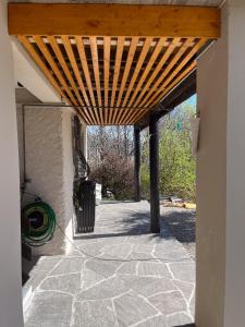 a wooden pergola on the side of a building at Casa Roccolo in Astano