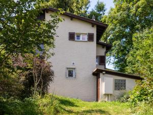 a large white house on a hill with trees at Casa Roccolo in Astano