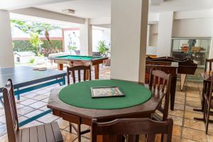 a room with ping pong tables and pool tables at Alimar Hotel in Natal