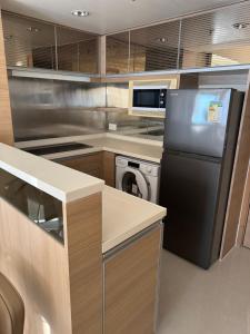 a kitchen with a refrigerator and a dishwasher at Harbour Nest in Hong Kong