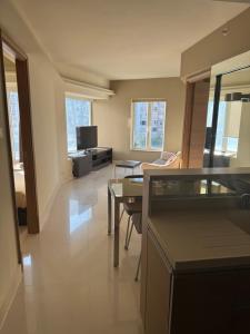 a living room with a couch and a table at Harbour Nest in Hong Kong