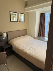 a bed in a room with a window at Harbour Nest in Hong Kong