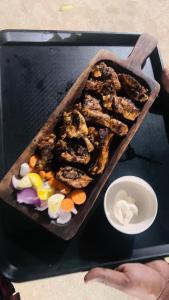 a tray of food on top of a grill at Hidden Roots Sakleshpur in Hanbalu