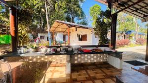 an outdoor kitchen with a table with food on it at Hidden Roots Sakleshpur in Hanbalu +35 photos