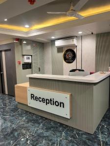 a reception desk in a hospital lobby with a reception counter at Hotel Sun Icon in Vadodara