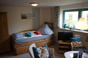 a bedroom with a bed with pillows and a television at Ferienwohnung Küssner in Kiel