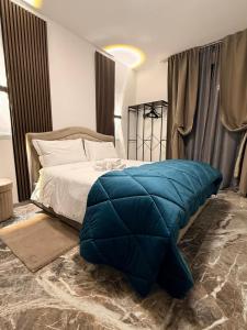 a bedroom with a bed with a blue pillow on it at DyAndy Suites Expo Milano in Baranzate