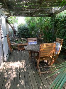a patio with a table and chairs on a deck at La Escala in La Celle-sous-Gouzon