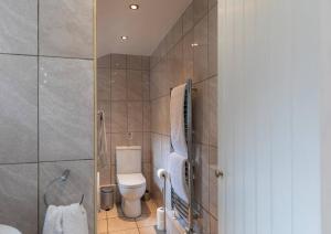 a bathroom with a toilet and a shower at Spacious Seafront Apartment, Garden Free Parking in Littlehampton +31 photos