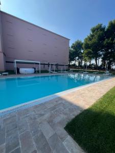 a swimming pool in front of a building at Domus Stella Maris - Casa per Ferie in Ancona
