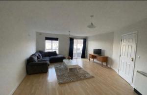 a living room with a couch and a table at Large 3 bed Duplex Apartment - Rhebogue Limerick in Limerick