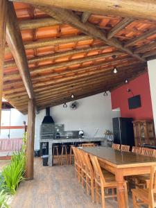 a large dining room with a table and chairs at Pousada Recanto das Águas - Fama MG in Fama