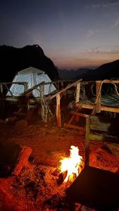 a fire pit with a tent and a campfire at Papae viewpoint with camping in Ban Ngoy-Nua