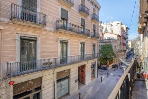 an apartment building with balconies on a city street at Flateli Nord in Girona