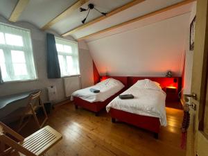 a room with two beds and a desk in it at 't ouw ateljeeke in Budel