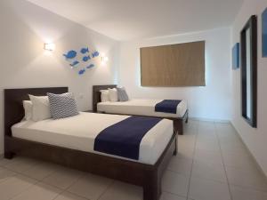 a hotel room with two beds and a tv at SOL by Meliá Dunas Family Fun in Santa Maria +34 photos