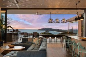a living room with a couch and a view of the ocean at Infinity Pool Villa , 4 Suites & Private Casita in Tamarindo