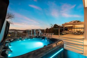 a hot tub on the balcony of a house at Infinity Pool Villa , 4 Suites & Private Casita in Tamarindo