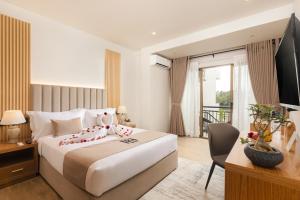 a hotel room with a bed and a television at Royal Avenue Kandy in Kandy