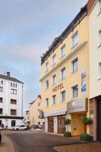 a hotel building with a hotel sign on the side of it at Hotel zur Mühle in Paderborn